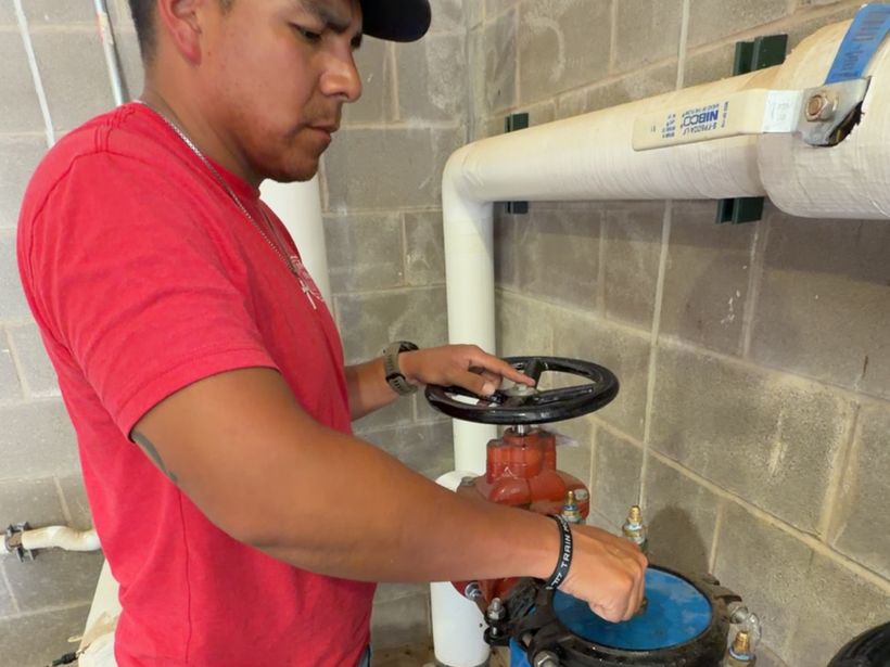 Double R technician servicing a backflow prevention assembly
